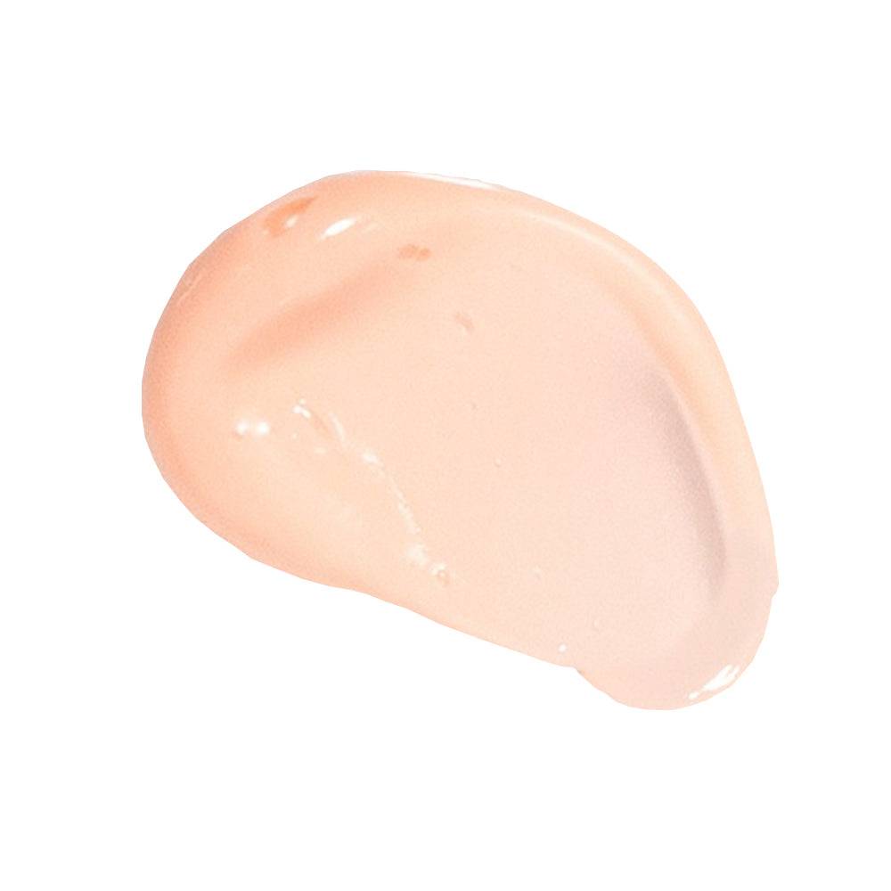 Close-up of Glytone Mild Cream Cleanser texture showing smooth, peach-toned cream ideal for gentle exfoliation and skin rejuvenation.
