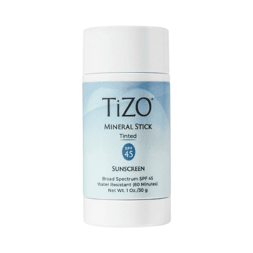 TiZO Mineral Stick Tinted SPF 45 sunscreen in a compact twist-up tube, ideal for touch-ups and travel skincare protection.