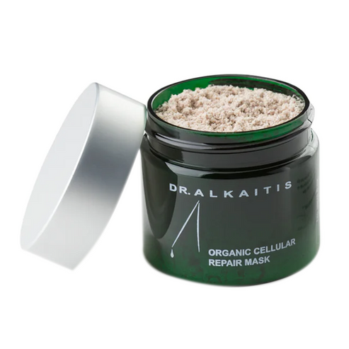 Dr Alkaitis Organic Flower Mask in a dark green jar with silver lid, featuring a powdered botanical formula for revitalizing facial skincare.