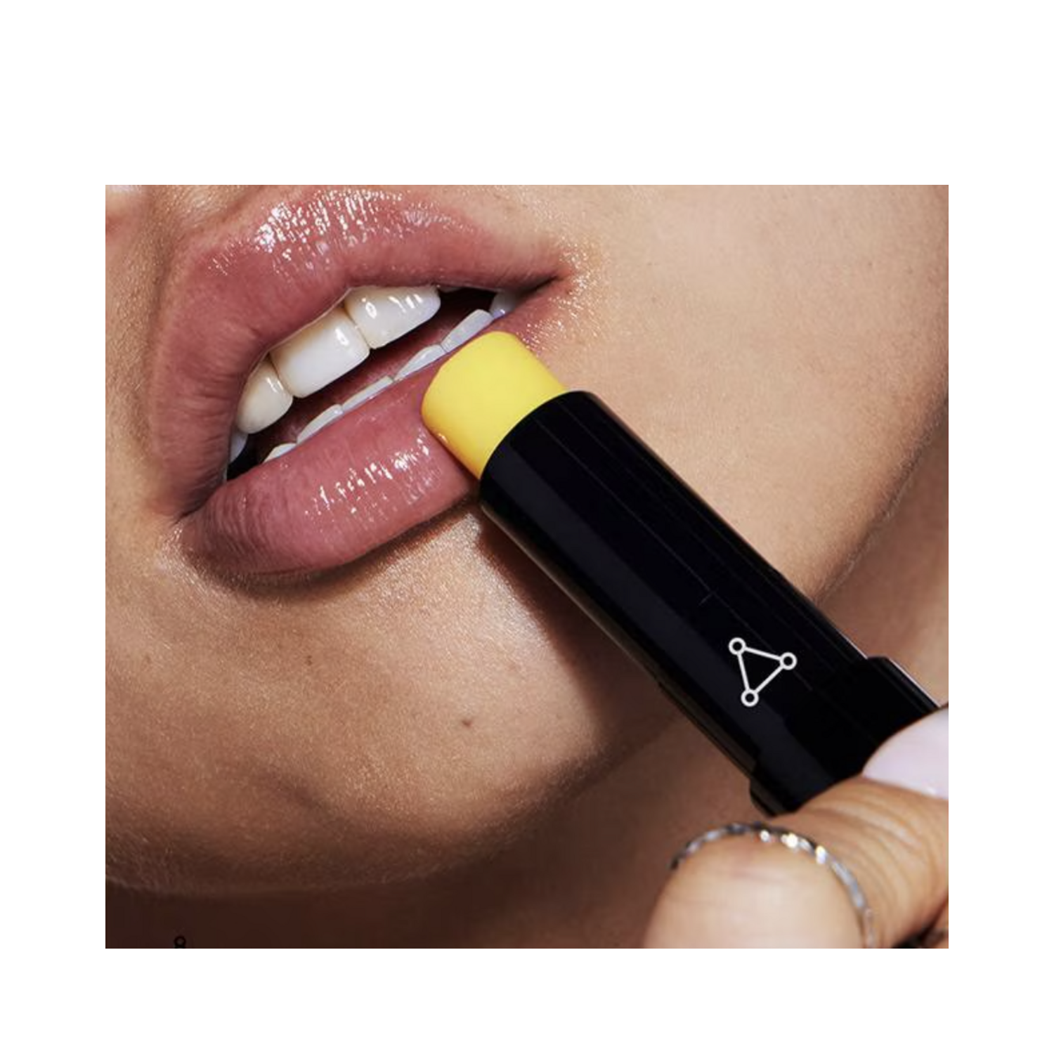 Model applying Allies of Skin Peptide Ceramide Lip Balm, showing smooth, hydrated lips for lip care and treatment.