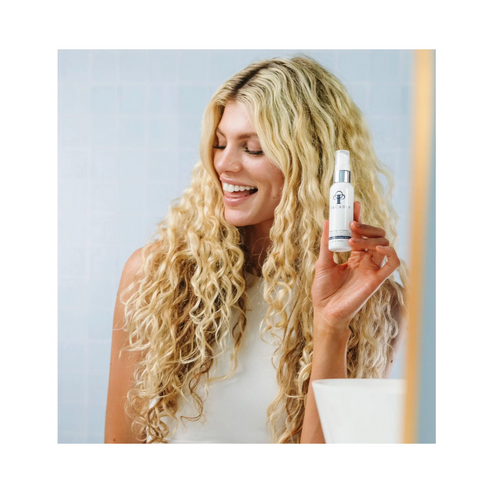 Smiling woman holding Circadia PhiTo-Pep 1.6 moisturiser, promoting its use for dry and mature skin in a daily skincare routine.