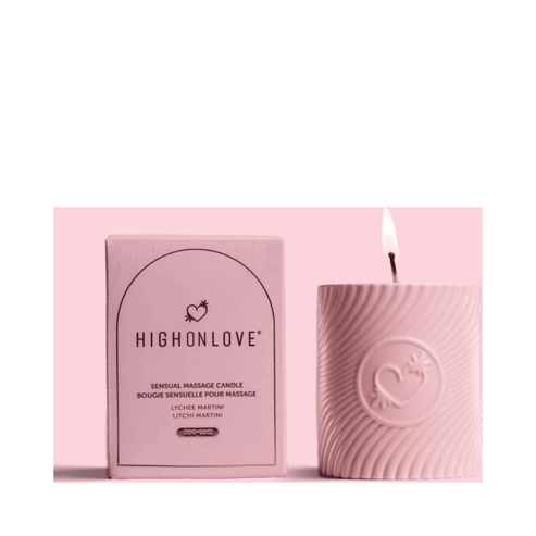 High on Love Pink Massage Candle lit beside branded box, Strawberries and Champagne scent from eSkinStore Candles & Home Scents collection.