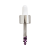 Close-up of Mount Lai facial oil dropper with purple-tinted serum. Designed to balance and hydrate skin using traditional plant root remedies.