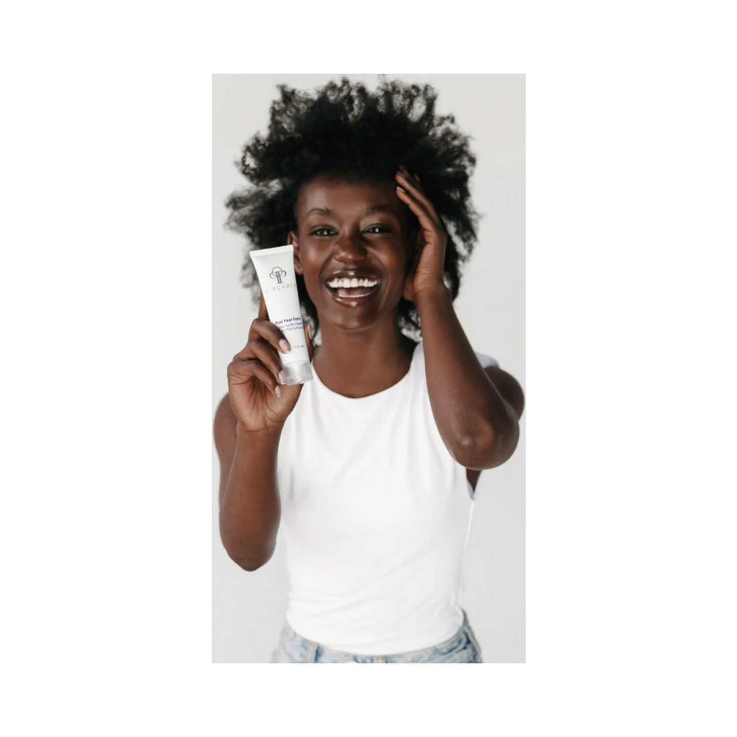 Smiling woman holding Circadia Post Peel Balm tube, showcasing skincare for post-treatment comfort and hydration in face serum category.