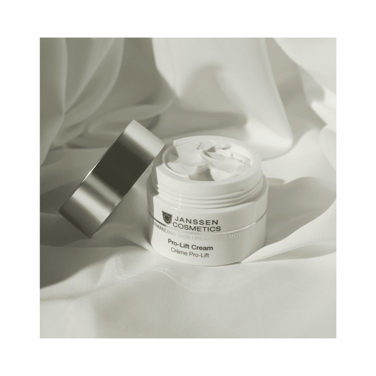 Open Janssen Cosmetics Pro-Lift Cream jar on soft fabric, showcasing rich texture for dry skin and fine lines treatment.