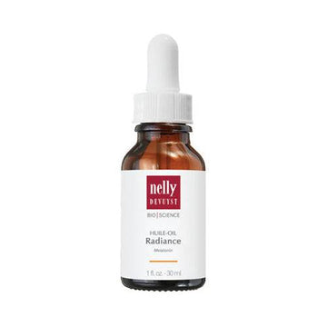 Nelly Devuyst Radiance Oil face moisturizer with melatonin in amber dropper bottle for youthful skin vitality and glow.