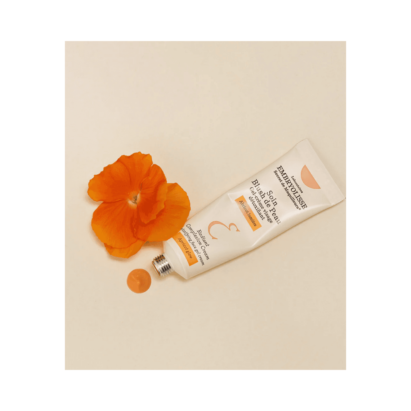 Embryolisse Radiant Complexion Cream - Apricot Glow tube with apricot flower and cream swatch, highlighting skincare benefits and natural glow.