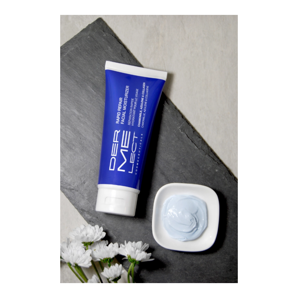 Flat lay of Dermelect Rapid Repair Moisturizer with open cream and flowers, highlighting natural ingredients for soothing facial care.