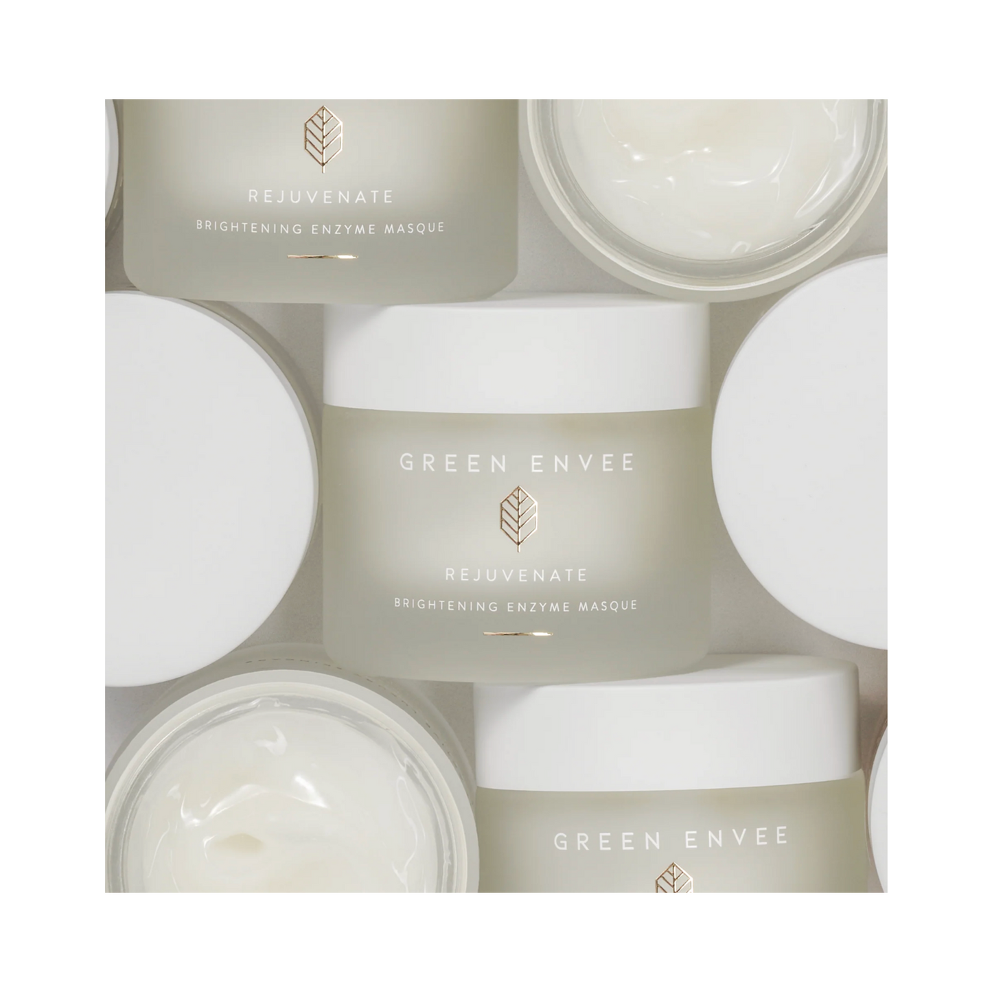 Flat lay of Green Envee Rejuvenate Brightening Enzyme Face Mask jars with open lids. Brightening enzyme face mask for skin care routines.