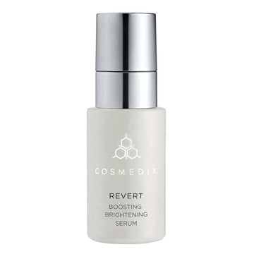 CosMedix Revert Serum - Brightening Boosting face serum in sleek white bottle with silver pump, ideal for reducing age spots and dull skin.