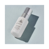 CosMedix Revert Brightening Boosting Serum bottle on light blue background, perfect for skincare routines targeting uneven skin tone.