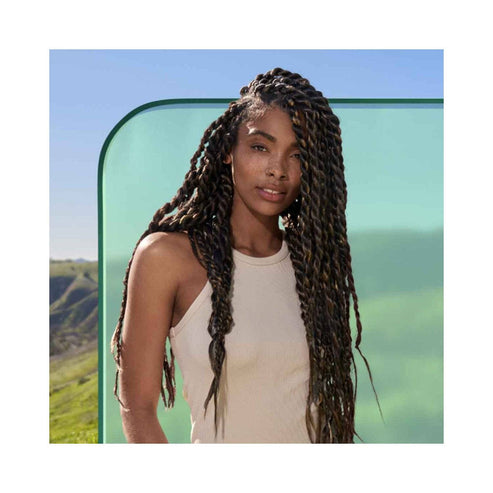 Model with long, healthy braids showcasing results of Biolage Scalp Sync Shampoo, promoting scalp hydration and hair care for all hair types.