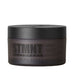 Primer plano del envase de STMNT Grooming Shine Paste
