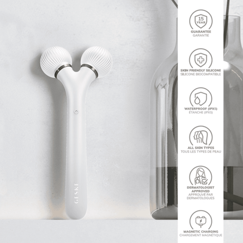 Black Geske Sonic Facial Roller mounted on wall with feature icons showing waterproof, skin-friendly silicone, and dermatologist-tested design.