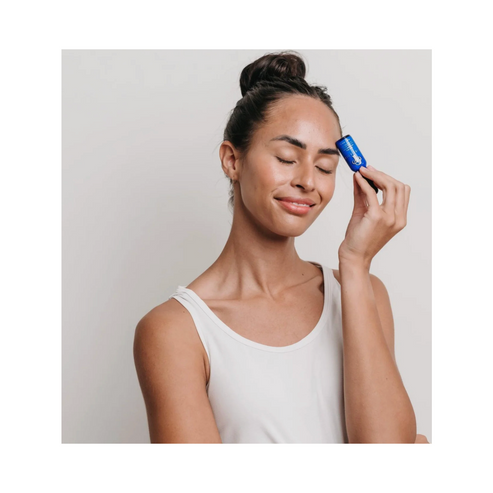 Woman applying Circadia Spot Stop serum to her face, showcasing targeted acne treatment for clear, healthy skin.