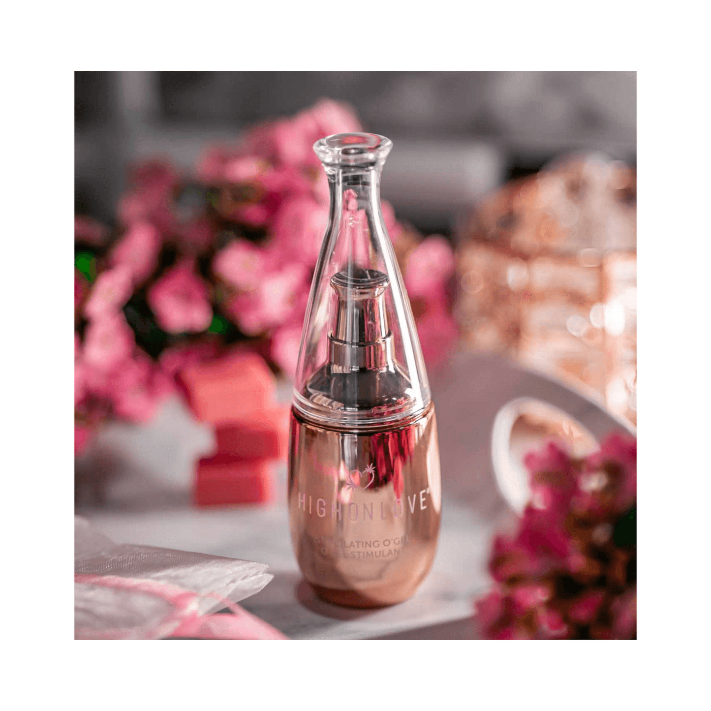 High on Love Stimulating O Gel Body Oil displayed with pink floral decor, 30 ml bottle ideal for intimate body care from eSkinStore.