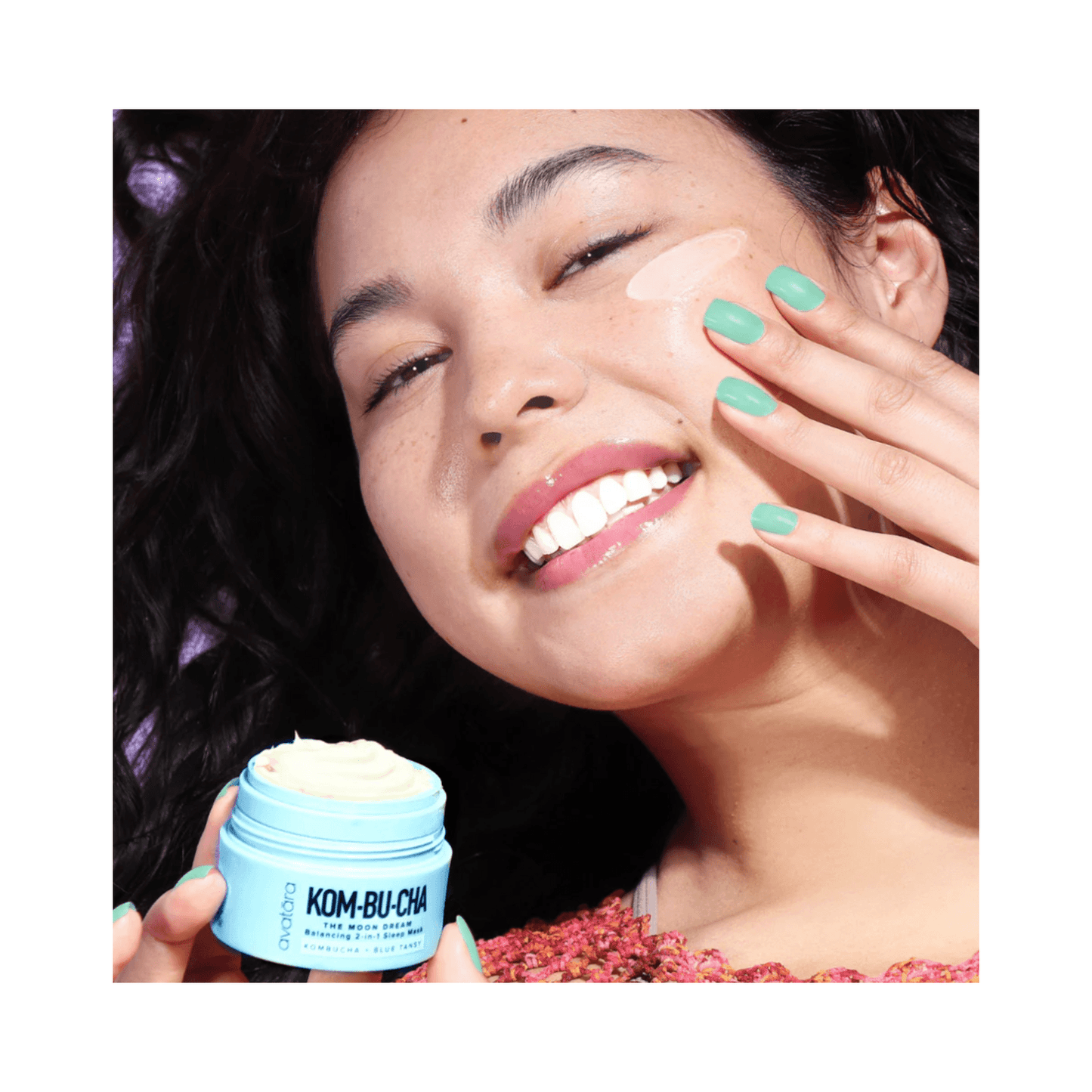 Smiling woman applying Avatara Moon Dream Mask 2-in-1 Sleep Cream, enriched with kombucha and blue tansy for radiant skin.