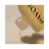Detail shot of Payot Toning Body Oil application, highlighting its smooth consistency for body care and skin firmness.
