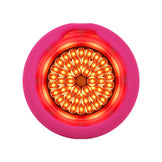 Foreo UFO 3 spa device with activated red LED light for deep skin nourishment and anti-aging facial treatment.