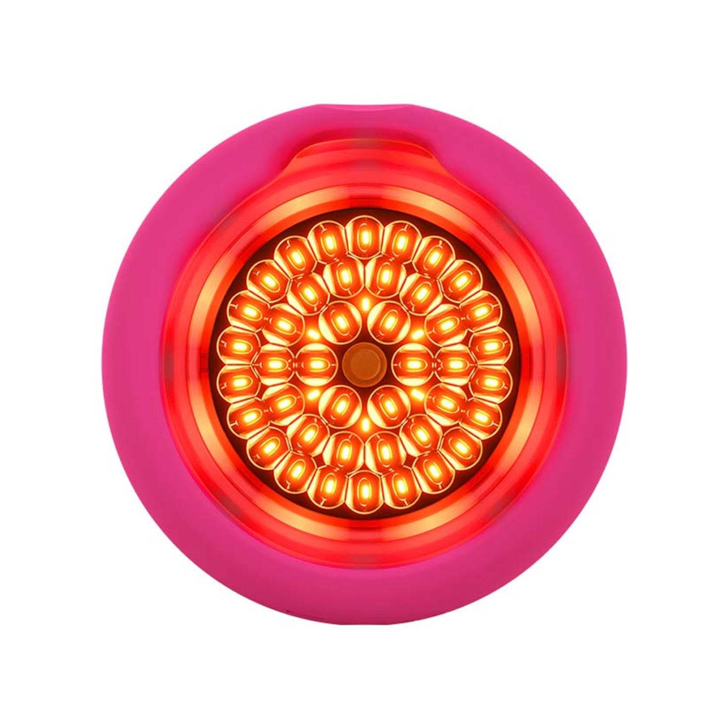 Foreo UFO 3 spa device with activated red LED light for deep skin nourishment and anti-aging facial treatment.