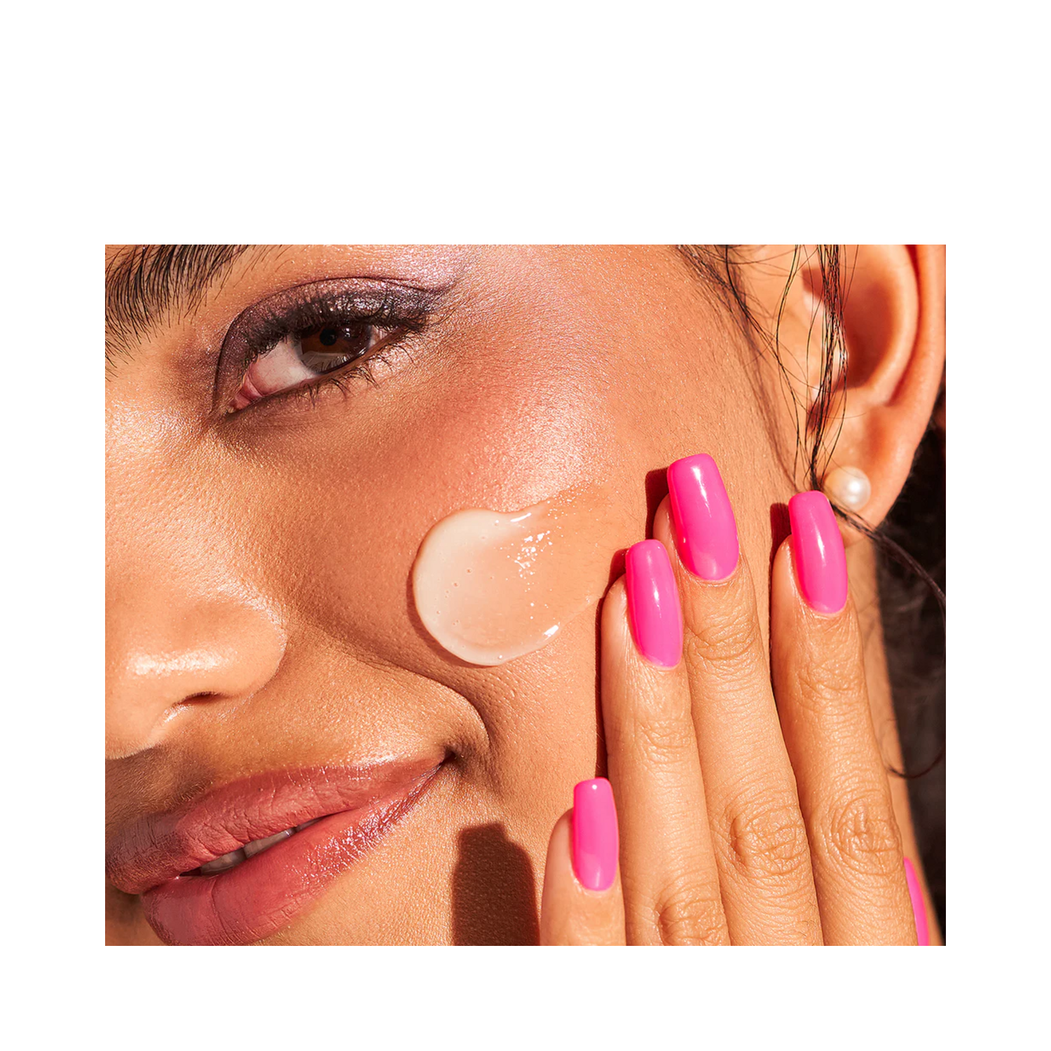 Woman applying Dr Dennis Gross Vitamin C Cleansing Oil to face, showing creamy consistency for gentle yet effective skin cleansing.