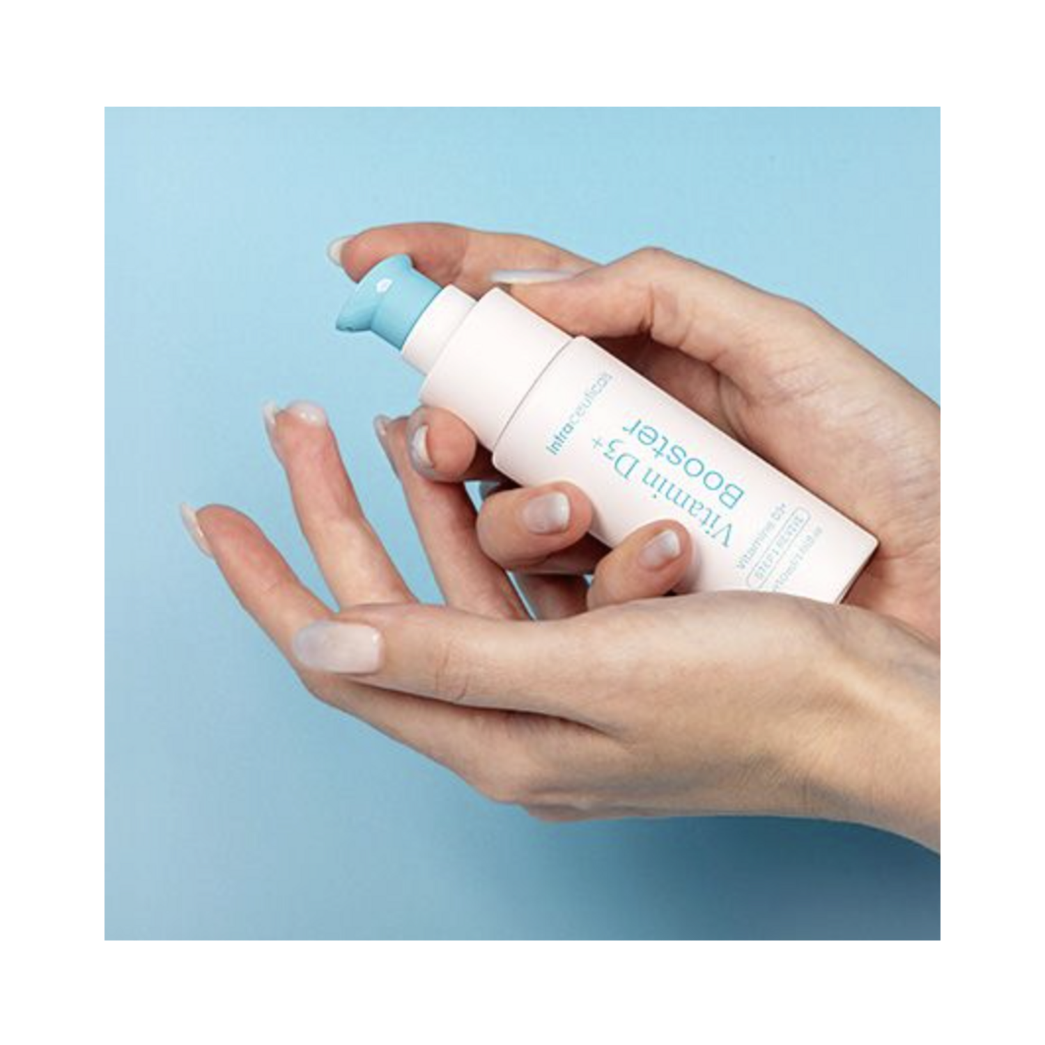 Hand applying Intraceuticals Vitamin D3+ Booster Serum, a skin-enhancing treatment for face and neck promoting resilience and calm complexion.