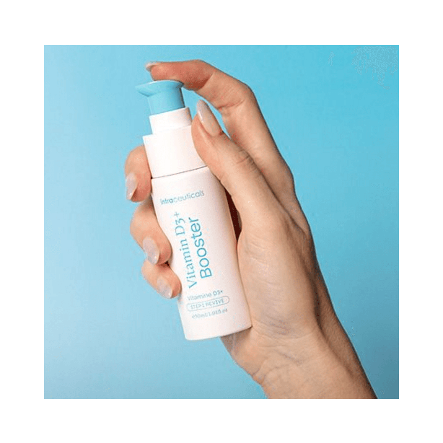 Intraceuticals Vitamin D3+ Booster held in hand against blue background, premium face serum for skin firmness, elasticity, and redness relief.