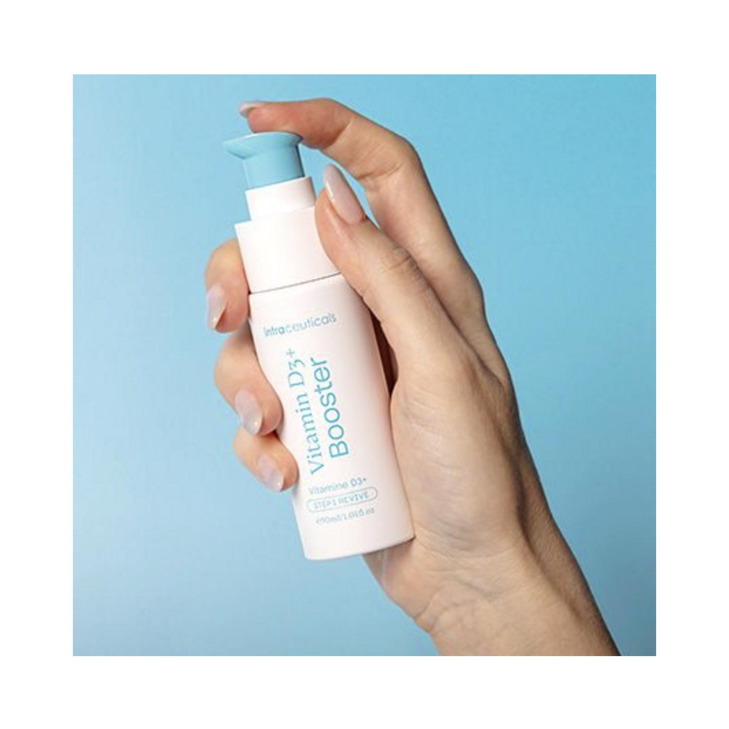Close-up of hand holding Intraceuticals Vitamin D3+ Booster, a revitalizing face serum for enhancing skin tone and reducing redness.